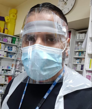 Picture of a Pharmacy manager wearing PPE